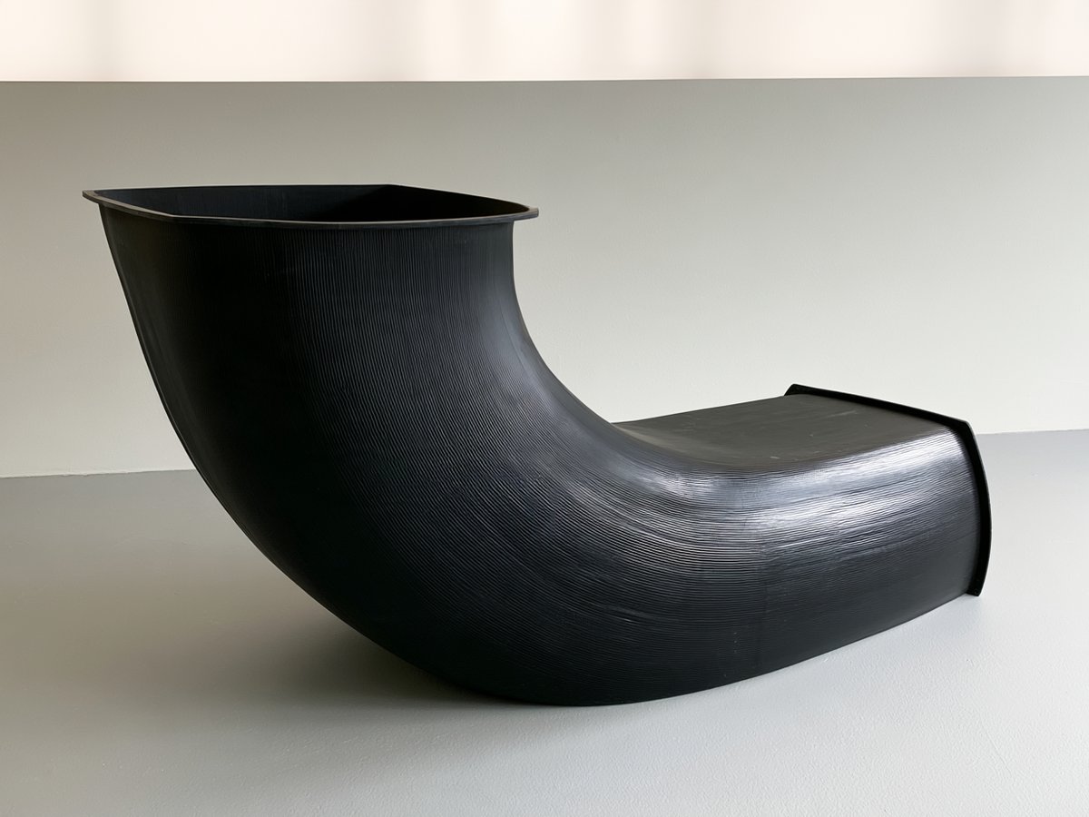 Large one-piece black plastic duct elbow with flanged ends