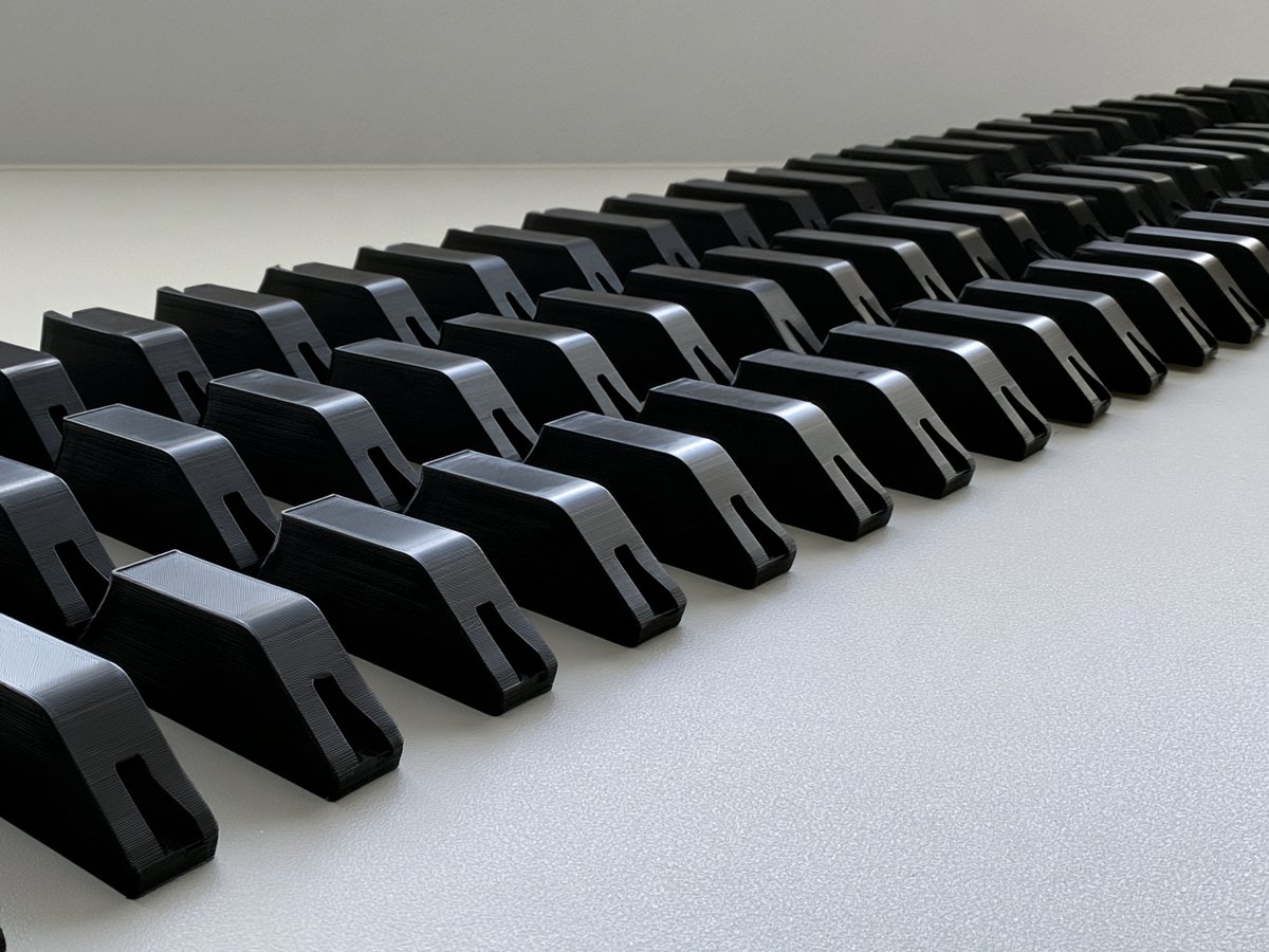 Rows of identical black plastic brackets