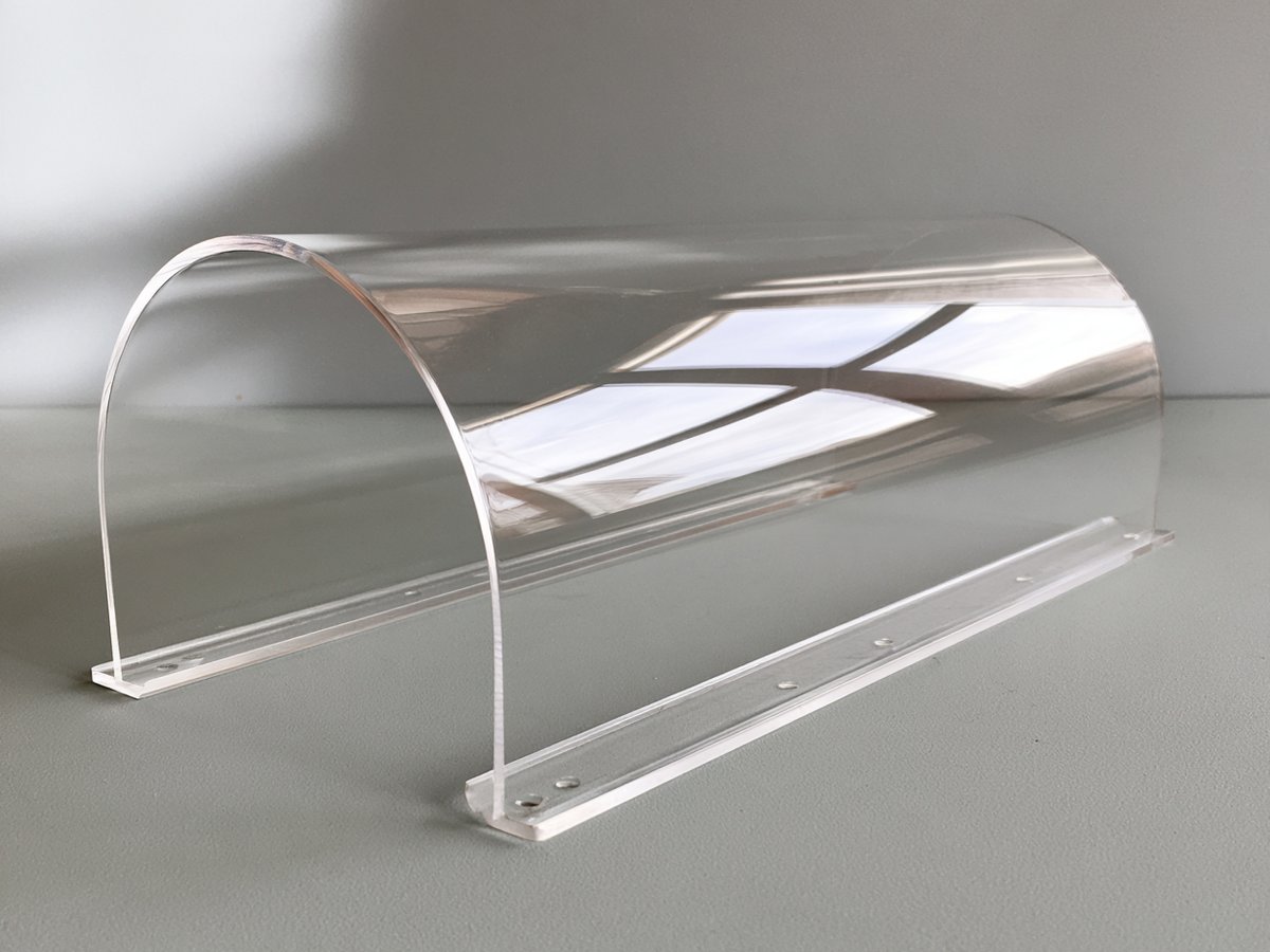 Clear thick acrylic half-round machine enclosure with flanged sides